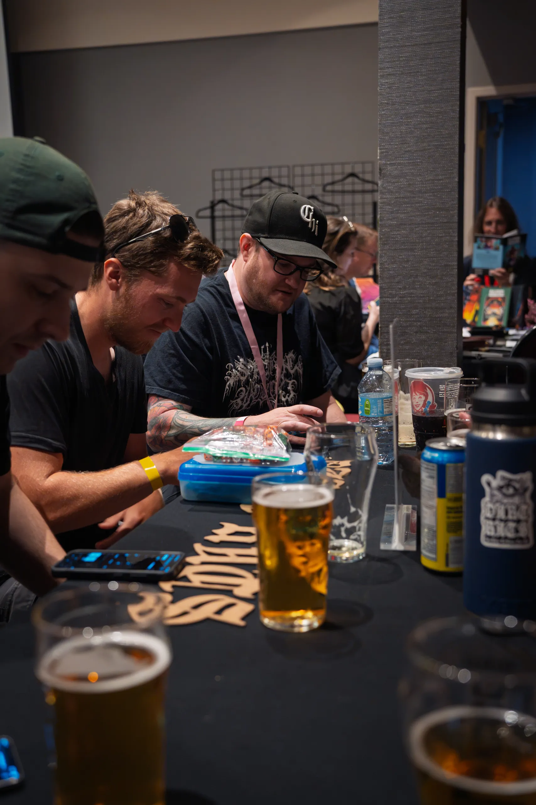 Two attendees reading over materials at the table, lanyards on.