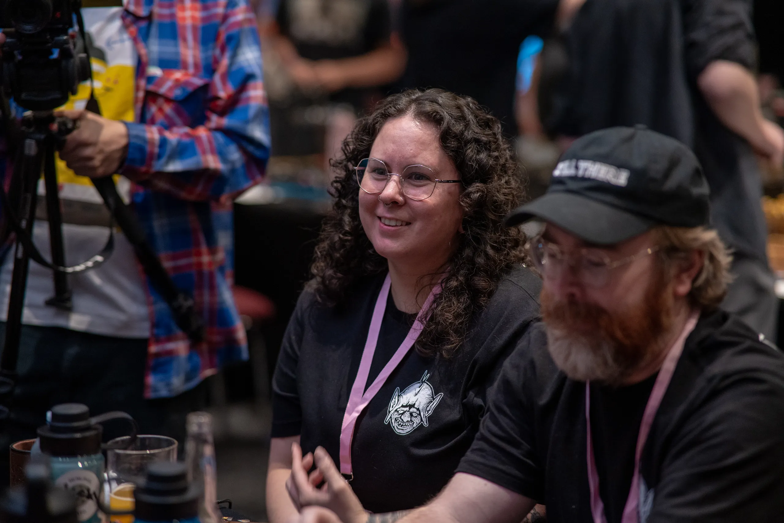 A player in a cap watching the table in profile.