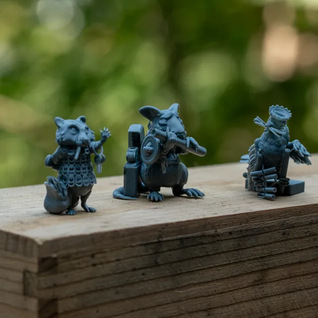 All three minis lined up on a wooden beam