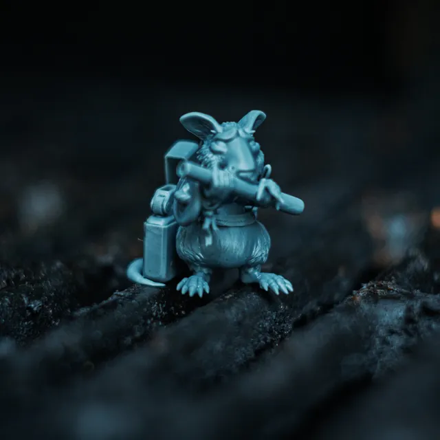 The Rat mini standing on a rusted grill